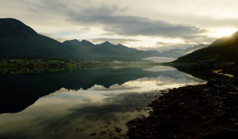 Mountains reflecting in a calm lake at sunrise