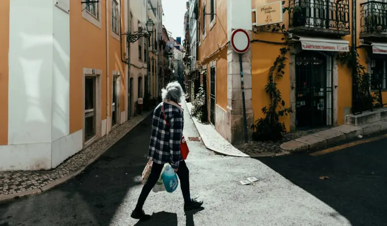 a person walking down a street with a bag