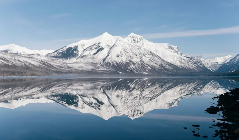 Snow-covered mountains reflected in a calm lake